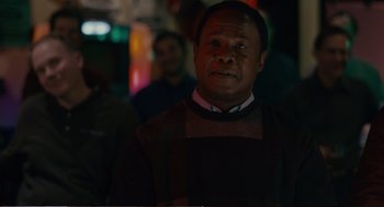 Movie still from “Cedar Rapids” (2011), directed by Miguel Arteta – A man standing in the dark with his eyes wide open; Close Up shot, Over the shoulder angle