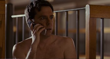 Movie still from “Cedar Rapids” (2011), directed by Miguel Arteta – A shirtless man talking on a cell phone; Close Up shot, Low angle