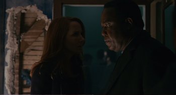 Movie still from “Cedar Rapids” (2011), directed by Miguel Arteta – A man and a woman standing next to each other in a room; Close Up shot, Over the shoulder angle