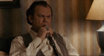 Movie still from “Cedar Rapids” (2011), directed by Miguel Arteta – A man in a white dress shirt and tie holding a tie; Close Up shot, Low angle