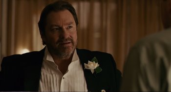 Movie still from “Cedar Rapids” (2011), directed by Miguel Arteta – A person wearing a suit and tie; Close Up shot, Over the shoulder angle