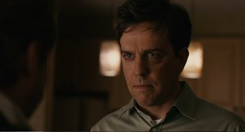 Movie still from “Cedar Rapids” (2011), directed by Miguel Arteta – A person wearing a green shirt; Close Up shot, Over the shoulder angle