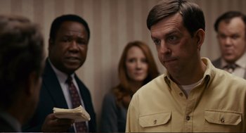 Movie still from “Cedar Rapids” (2011), directed by Miguel Arteta – A man and a woman standing next to each other in a room; Close Up shot, Over the shoulder angle