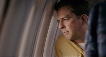 Movie still from “Cedar Rapids” (2011), directed by Miguel Arteta – A person looking out a window; Close Up shot, Low angle