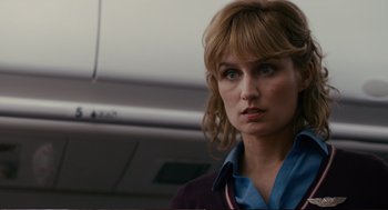 Movie still from “Cedar Rapids” (2011), directed by Miguel Arteta – A person wearing a shirt and jacket; Close Up shot, Over the shoulder angle