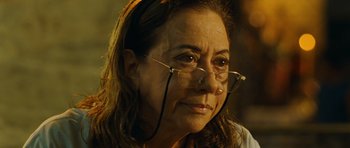 Movie still from “Central Station” (1998), directed by Walter Salles – An older woman wearing glasses looking at the camera; Close Up shot, Over the shoulder angle