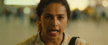 Movie still from “Central Station” (1998), directed by Walter Salles – A young woman with brown hair and a white shirt; Close Up shot, Low angle