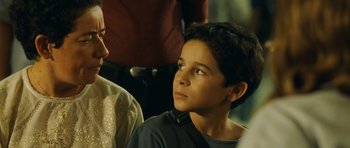 Movie still from “Central Station” (1998), directed by Walter Salles – A young boy sitting next to another boy; Close Up shot, Over the shoulder angle