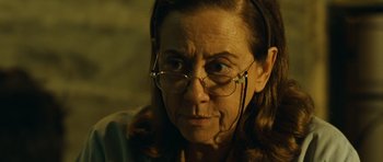 Movie still from “Central Station” (1998), directed by Walter Salles – An older woman wearing glasses and a headset; Close Up shot, Over the shoulder angle