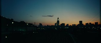 Movie still from “Central Station” (1998), directed by Walter Salles – A view of a city skyline at night with a clock tower; Extreme Wide shot, High angle