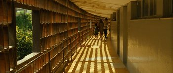 Movie still from “Central Station” (1998), directed by Walter Salles – A couple of people walking down a long hallway; Extreme Wide shot, Low angle