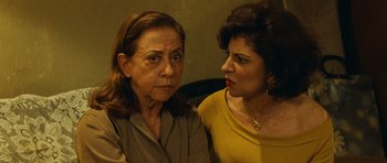 Movie still from “Central Station” (1998), directed by Walter Salles – Two older women sitting next to each other in a room; Close Up shot, Over the shoulder angle