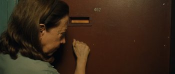 Movie still from “Central Station” (1998), directed by Walter Salles – A woman leaning up against a brown wall; Close Up shot, Low angle