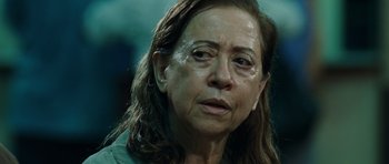 Movie still from “Central Station” (1998), directed by Walter Salles – An older woman with brown eyes and long brown hair; Close Up shot, Over the shoulder angle