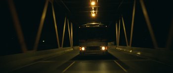Movie still from “Central Station” (1998), directed by Walter Salles – A bus driving down a street at night; Extreme Wide shot, Low angle