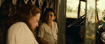 Movie still from “Central Station” (1998), directed by Walter Salles – A man and a boy sitting on a train; Close Up shot, Over the shoulder angle