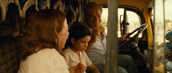 Movie still from “Central Station” (1998), directed by Walter Salles – A man and a woman sitting next to a boy on a bus; Medium shot, Over the shoulder angle