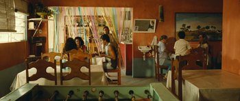 Movie still from “Central Station” (1998), directed by Walter Salles – A group of people sitting around a room; Wide shot, High angle