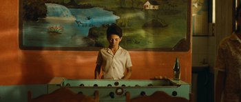 Movie still from “Central Station” (1998), directed by Walter Salles – A woman standing in front of a table with balls on it; Medium shot, High angle