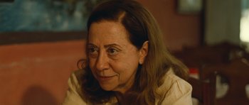 Movie still from “Central Station” (1998), directed by Walter Salles – An older woman with long brown hair looking at the camera; Close Up shot, Over the shoulder angle