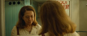 Movie still from “Central Station” (1998), directed by Walter Salles – A woman looking at her reflection in a mirror; Close Up shot, Over the shoulder angle