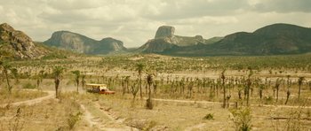 Movie still from “Central Station” (1998), directed by Walter Salles – A bus driving down a dirt road in the middle of the desert; Extreme Wide shot, Low angle
