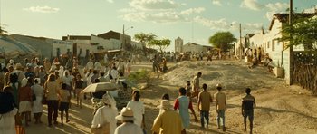 Movie still from “Central Station” (1998), directed by Walter Salles – A group of people walking down a dirt road; Extreme Wide shot, High angle