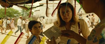 Movie still from “Central Station” (1998), directed by Walter Salles – A woman and a boy are standing next to each other; Close Up shot, Over the shoulder angle