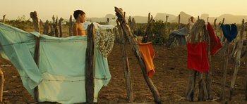 Movie still from “Central Station” (1998), directed by Walter Salles – A young boy hanging clothes out to dry in the sun; Wide shot, Low angle