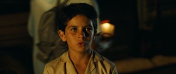 Movie still from “Central Station” (1998), directed by Walter Salles – A young boy with a surprised look on his face; Close Up shot, Over the shoulder angle