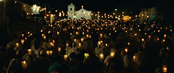 Movie still from “Central Station” (1998), directed by Walter Salles – A large group of people gathered in the dark holding candles; Extreme Wide shot, High angle