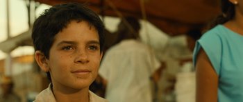 Movie still from “Central Station” (1998), directed by Walter Salles – A young boy is looking into the camera; Close Up shot, Over the shoulder angle