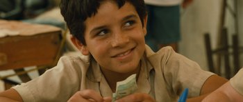 Movie still from “Central Station” (1998), directed by Walter Salles – A young boy is holding a piece of paper; Close Up shot, Over the shoulder angle