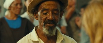 Movie still from “Central Station” (1998), directed by Walter Salles – An old man with a beard and a hat; Close Up shot, Over the shoulder angle