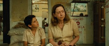 Movie still from “Central Station” (1998), directed by Walter Salles – A woman and a boy sitting next to each other; Medium shot, Over the shoulder angle