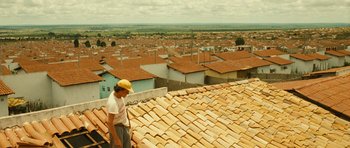 Movie still from “Central Station” (1998), directed by Walter Salles – A man standing on a roof looking over a city; Wide shot, Low angle