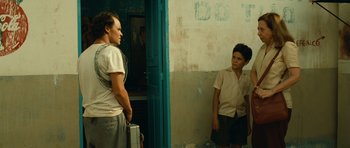 Movie still from “Central Station” (1998), directed by Walter Salles – Two young men standing in front of a door; Medium shot, Over the shoulder angle