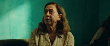 Movie still from “Central Station” (1998), directed by Walter Salles – An older woman with long brown hair wearing a white shirt; Close Up shot, Over the shoulder angle