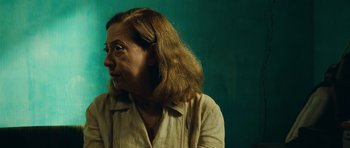 Movie still from “Central Station” (1998), directed by Walter Salles – A person wearing glasses and a white shirt; Close Up shot, Over the shoulder angle