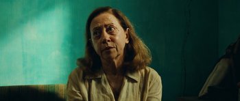 Movie still from “Central Station” (1998), directed by Walter Salles – An older woman with long brown hair looking up; Close Up shot, Over the shoulder angle