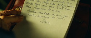 Movie still from “Central Station” (1998), directed by Walter Salles – A handwritten note written in cursive; Extreme Close Up shot, Overhead angle