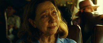 Movie still from “Central Station” (1998), directed by Walter Salles – An older woman is crying while sitting in a chair; Close Up shot, Over the shoulder angle