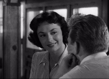 Movie still from “Champion” (1949), directed by Mark Robson – An old photo of a man and a woman; Close Up shot, Over the shoulder angle