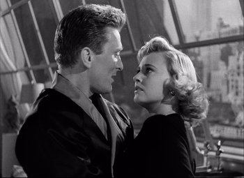 Movie still from “Champion” (1949), directed by Mark Robson – A black and white photo of a man and a woman; Close Up shot, Low angle