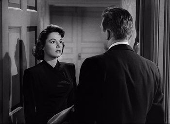 Movie still from “Champion” (1949), directed by Mark Robson – An old photo of a man and a woman looking at each other in front of a mirror; Medium shot, Over the shoulder angle