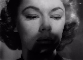 Movie still from “Champion” (1949), directed by Mark Robson – A black - and - white photo of a woman's face; Close Up shot, Overhead angle