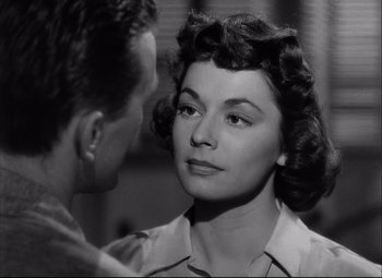 Movie still from “Champion” (1949), directed by Mark Robson – A man and a woman looking at one another; Close Up shot, Over the shoulder angle