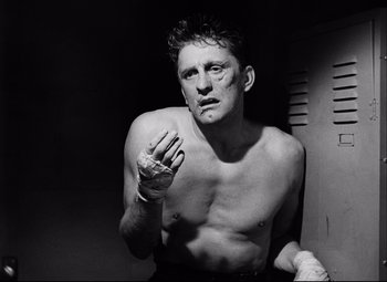 Movie still from “Champion” (1949), directed by Mark Robson – Black and white photograph of a man with bandaged hands; Close Up shot, Low angle