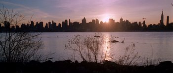 Movie still from “Changing Lanes” (2002), directed by Roger Michell – The sun is setting over a large body of water; Extreme Wide shot, High angle