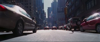 Movie still from “Changing Lanes” (2002), directed by Roger Michell – Cars driving down a busy street in a large city; Extreme Wide shot, High angle